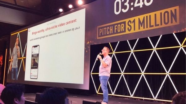 Vloggi founder Justin Wastnage on stage pitching for $1m