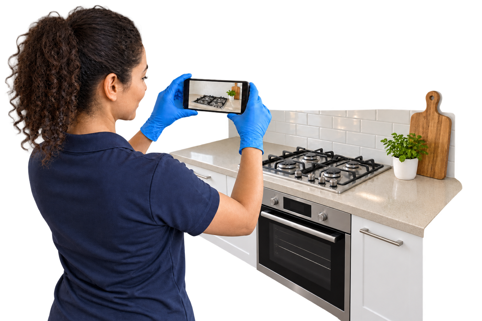 Cleaner recording the condition of a kitchen for a job report